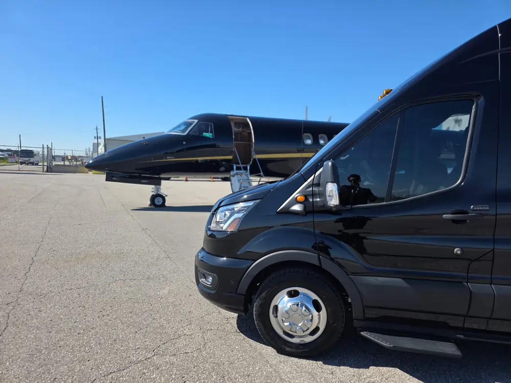Luxury black limousine with professional chauffeur providing premium airport transportation in Toronto, offering secure online booking and stress-free pick-up and drop-off.