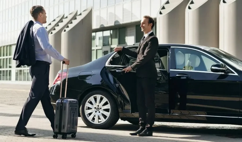 Limo driver welcoming passenger with a smile at Pearson Airport – professional chauffeur service in Toronto