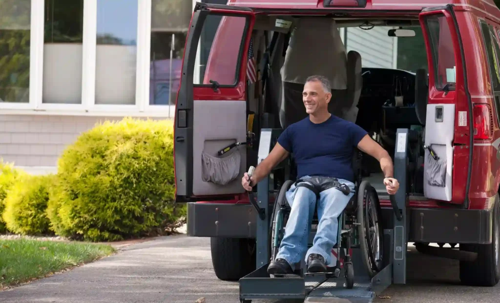 Passenger exiting a wheelchair-accessible limo at Toronto Pearson Airport, assisted while seated in a wheelchair.