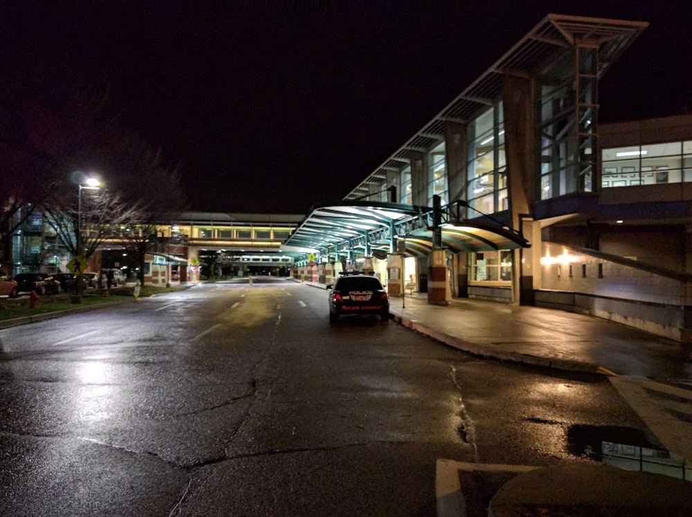 burlington limo service-A car is parked at the entrance of a building, indicating a designated drop-off or parking area for burlington limo service.