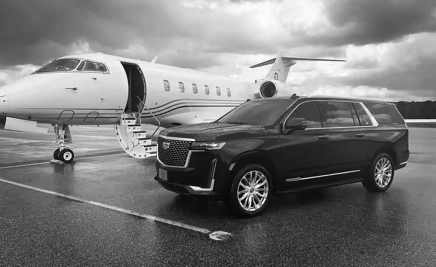 kitchener airport limo services-a luxury black limo is parked with a white private jet on the airport