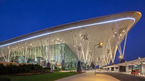 markham limo service-Modern airport terminal at night with sleek curves, glass facade, and illuminated structural supports; a calm, futuristic ambiance.