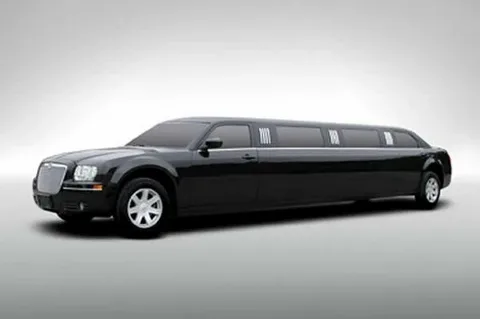 limo service milton-Sleek black limousine parked against a plain gray background. The long, elegant vehicle features tinted windows and a polished exterior, exuding luxury and sophistication.