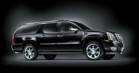 A sleek black SUV is shown with shiny chrome accents and large alloy wheels against a dark gradient background, conveying luxury and power.