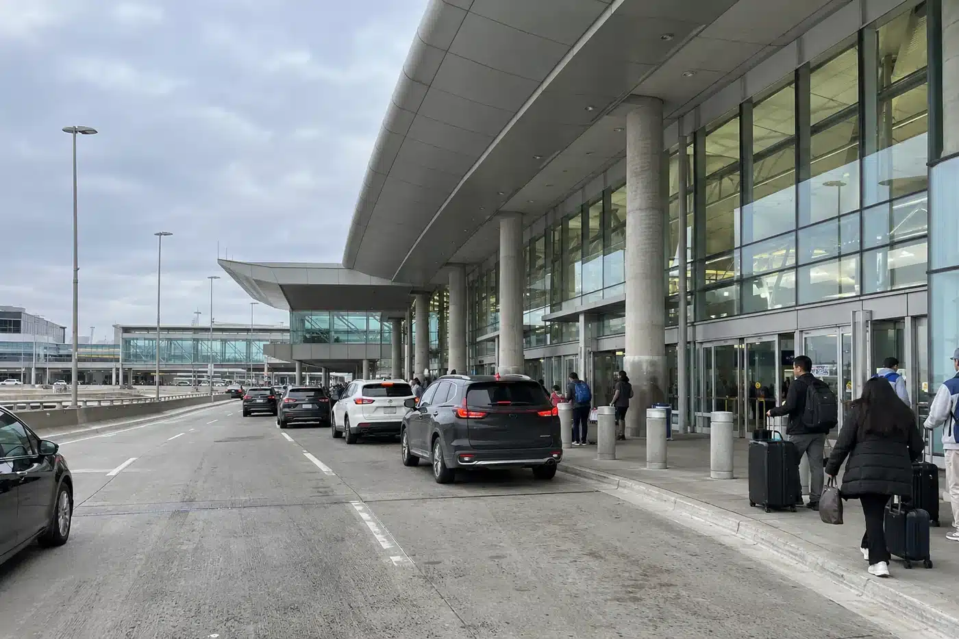 Cars at an airport terminal departures kerb