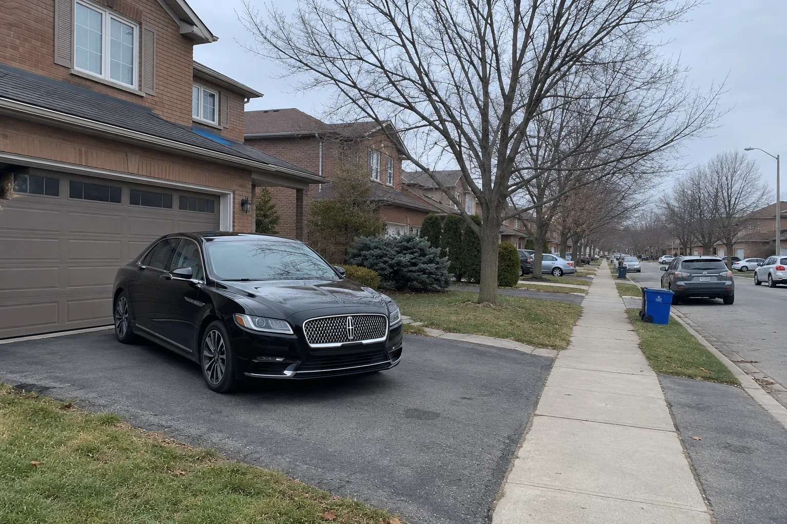 Suburban street with a car waiting at the kerb
